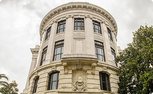 A majestic, white stone building with a round dome and columns.